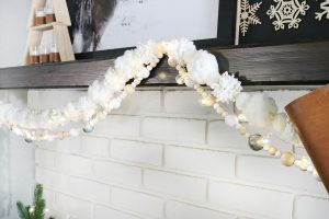 Casual Boho Christmas Decor - Mix textured pom-pom garlands with wood beads, and small twinkle lights.