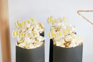 Black & White New Year's Eve Bar Cart Ideas - Simple Paper Bags Filled with Popcorn and Festive Decorations