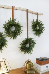 Create Simple and Easy Holiday Decor by Hanging Classic Holiday Wreaths with A Modern Twist